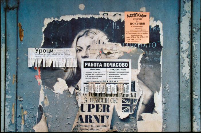 Sofia, 2002. It was my first trip to the city, and I didn't know anyone to talk to. I took photographs of all the walls, because they seemed to have a lot to say themselves. This woman, buried by layers of newer posters, is still haunting / © Rana Dasgupta